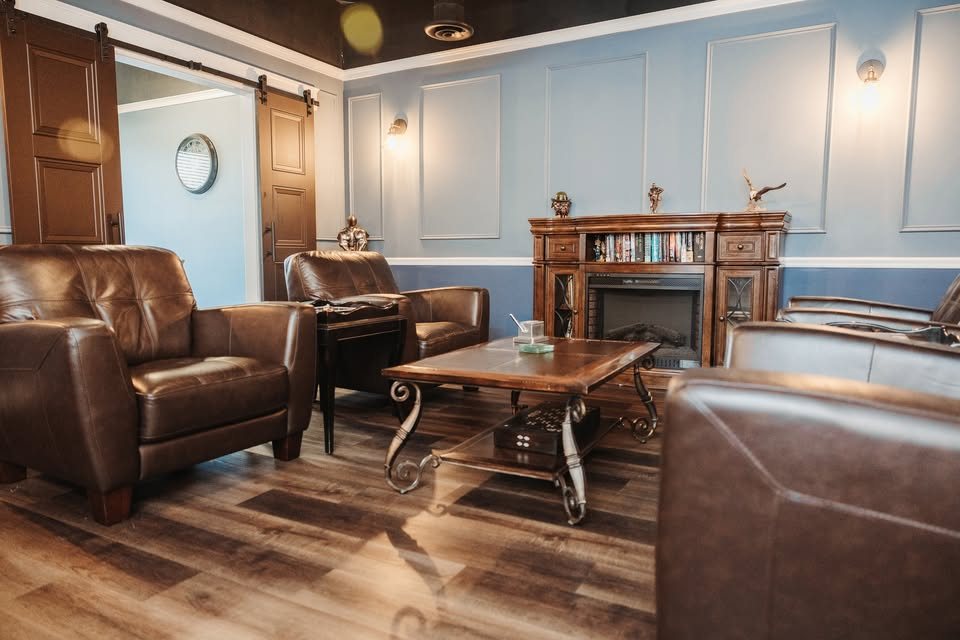 Leather club chairs and fireplace in the lounge